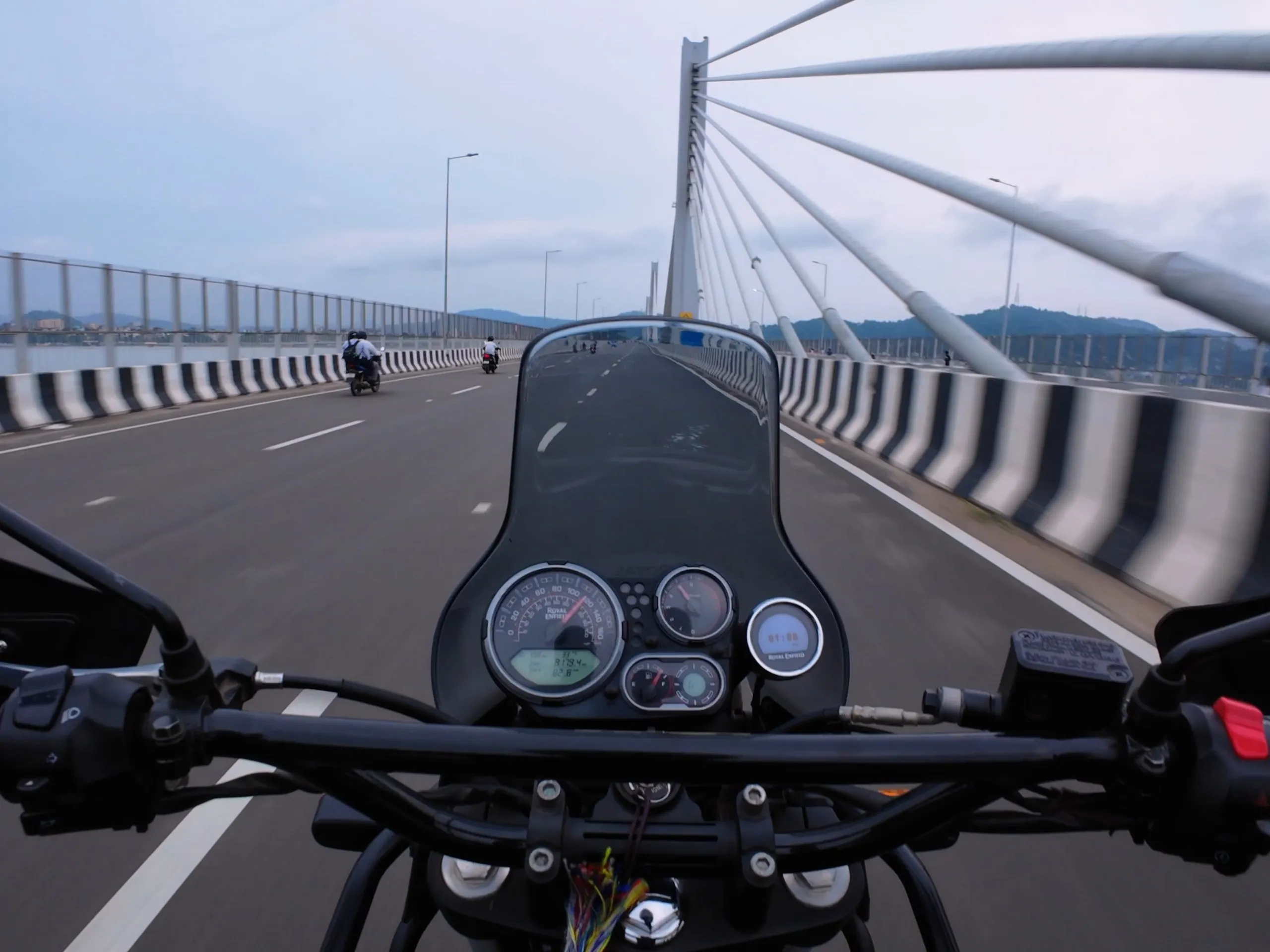 Rider’s view of the old-school Himalayan dash while crossing a cable-stayed bridge